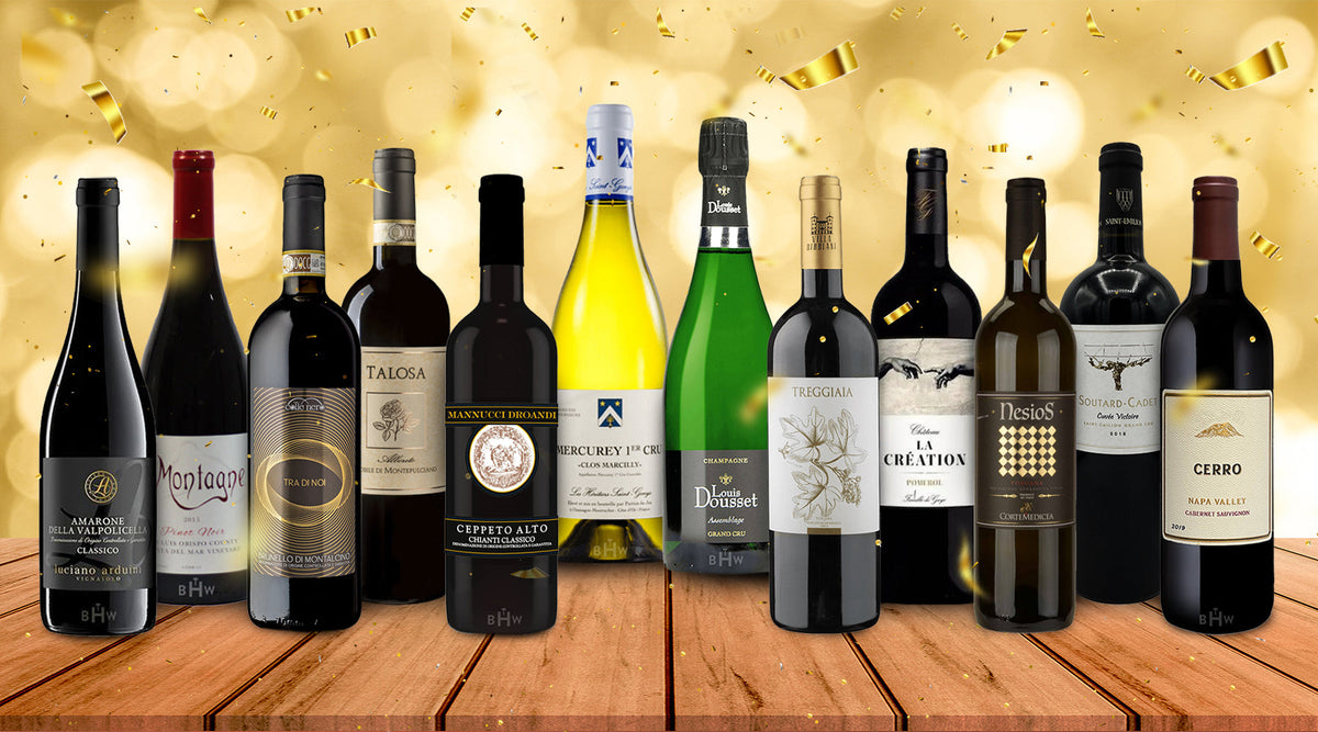 Twelve wine bottles lined up on a wooden surface against a gold confetti background