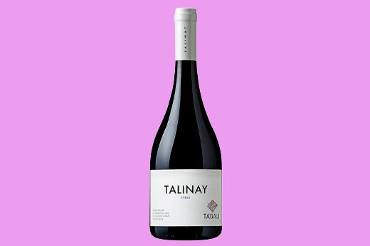 Bottle of 2014 Tabali Talinay Syrah, dark label reading Talinay, on a pink background