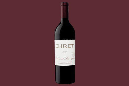 Bottle of 2017 Ehret Cabernet Sauvignon, Knights Valley, cream label, dark maroon background