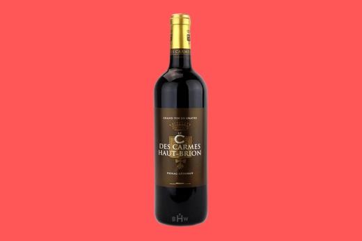 Bottle of 2019 Le C des Carmes Haut-Brion Pessac-Leognan, gold label, coral background
