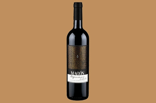 Bottle of 2020 Bollina Magon Negroamaro Salento, gold mesh label with white band, tan background