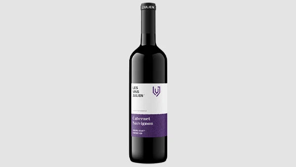 Bottle of Les Vins Julien Cabernet Sauvignon, white label with a purple band and shield