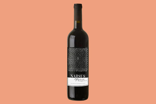 Bottle of 2021 Bollina Narses Aglianico, black dot-patterned label reading NARSES, on a salmon background
