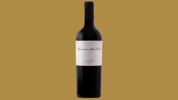 Bottle of Guerriero della Terra red wine with a small cream label, on a gold background