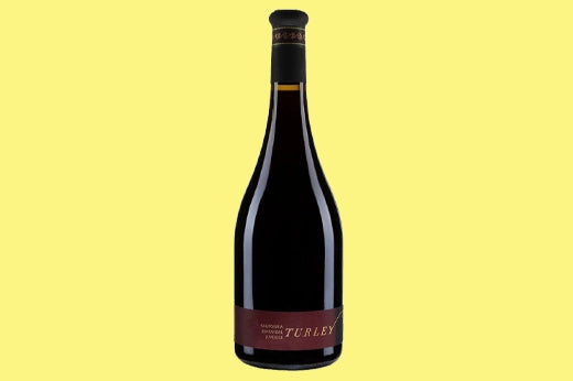 Bottle of 2021 Turley Old Vines Zinfandel, dark maroon label, on a yellow background