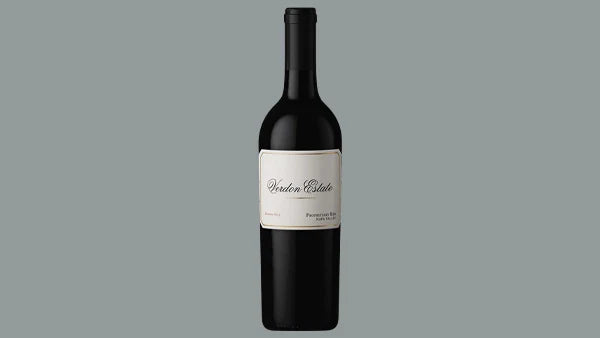 Bottle of Verdon Estate red wine with a plain cream label, on a grey background
