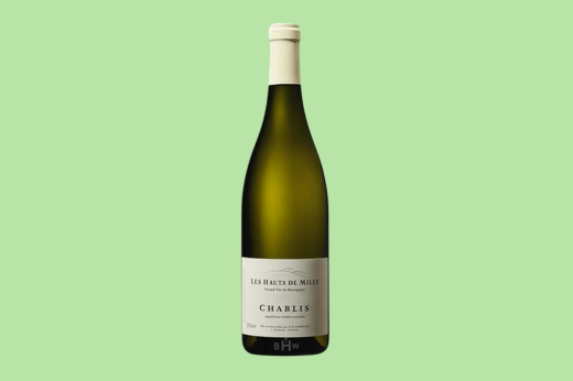 Bottle of 2022 Les Hauts de Milly Chablis with a cream label on a mint green background