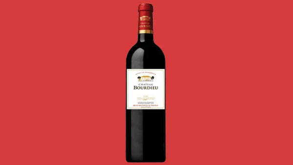 Bottle of 2023 Chateau Bourdieu Blaye Cotes de Bordeaux, cream label, on a red background