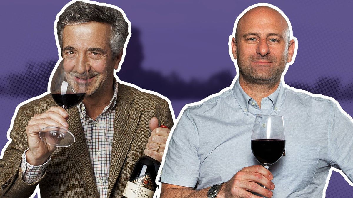 Eduardo Chadwick tasting red wine and holding a bottle, beside Greg Martellotto