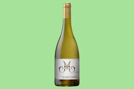 Bottle of 2021 M by Martellotto Chardonnay, Santa Barbara, pale gold wine in clear glass, white label