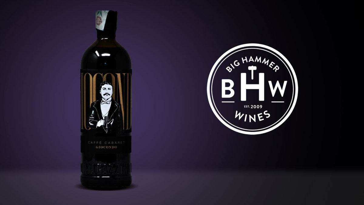 Dark bottle with a black label showing an illustrated seated figure, beside the Big Hammer Wines logo
