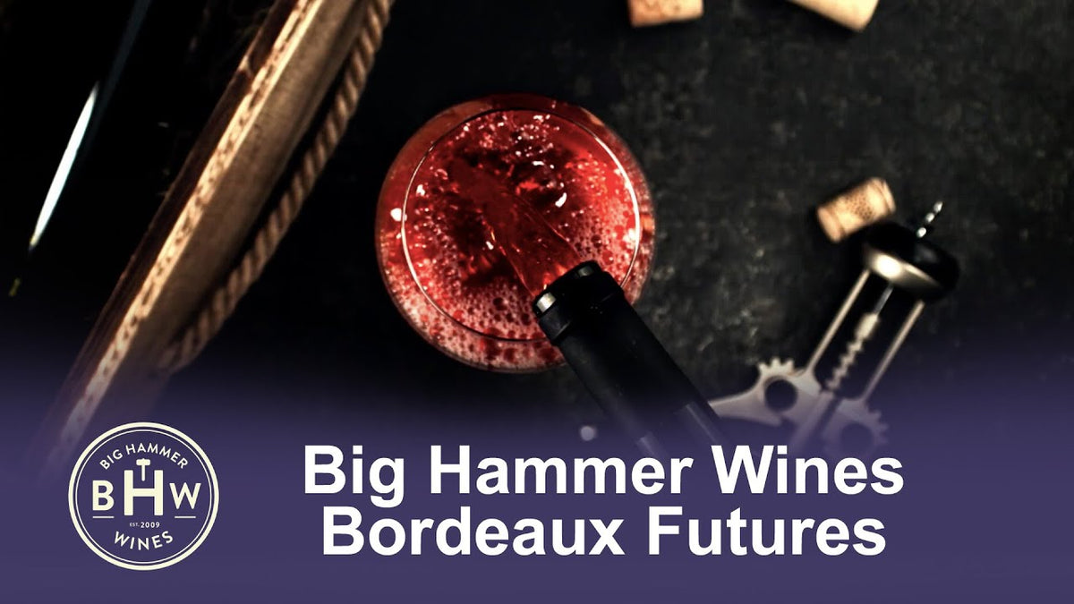 Graphic reading "Big Hammer Wines Bordeaux Futures" over a glass of red wine, corks and a corkscrew