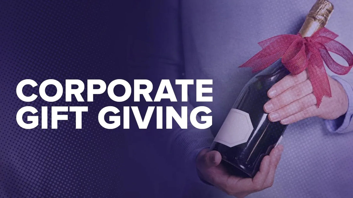 Graphic reading "Corporate Gift Giving" over a man holding a sparkling wine bottle tied with a red bow