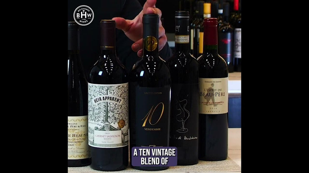 Hand lifting a bottle from a group of red wines, caption reading "A ten vintage blend of"