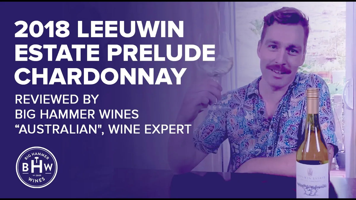 Man in a floral shirt beside a bottle of 2018 Leeuwin Estate Prelude Chardonnay