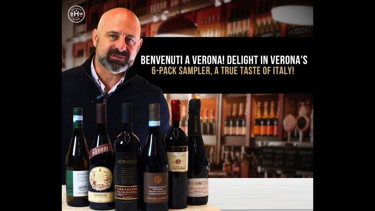 Man behind a bar with six Italian wine bottles, text reading "Benvenuti a Verona!"
