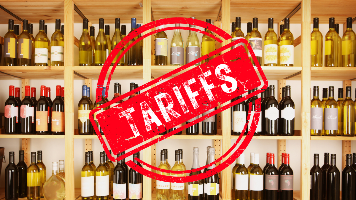 Red "Tariffs" rubber stamp over wooden shelves stocked with red and white wine bottles