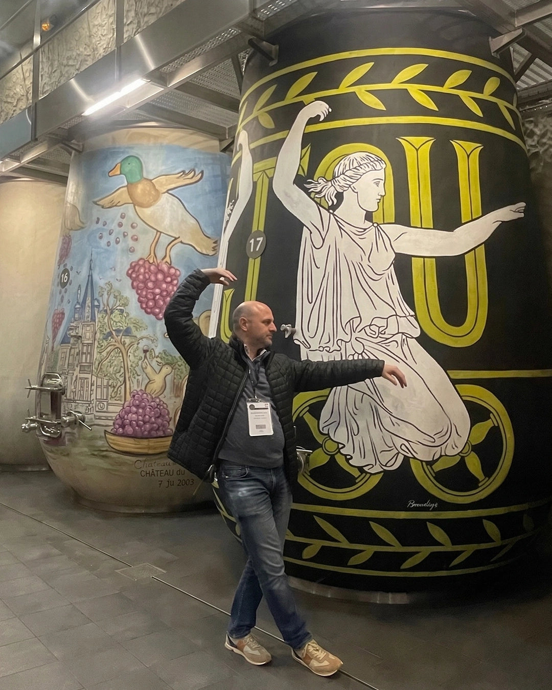 Greg Martellotto inside winery with large fermentation tanks wine expert on site