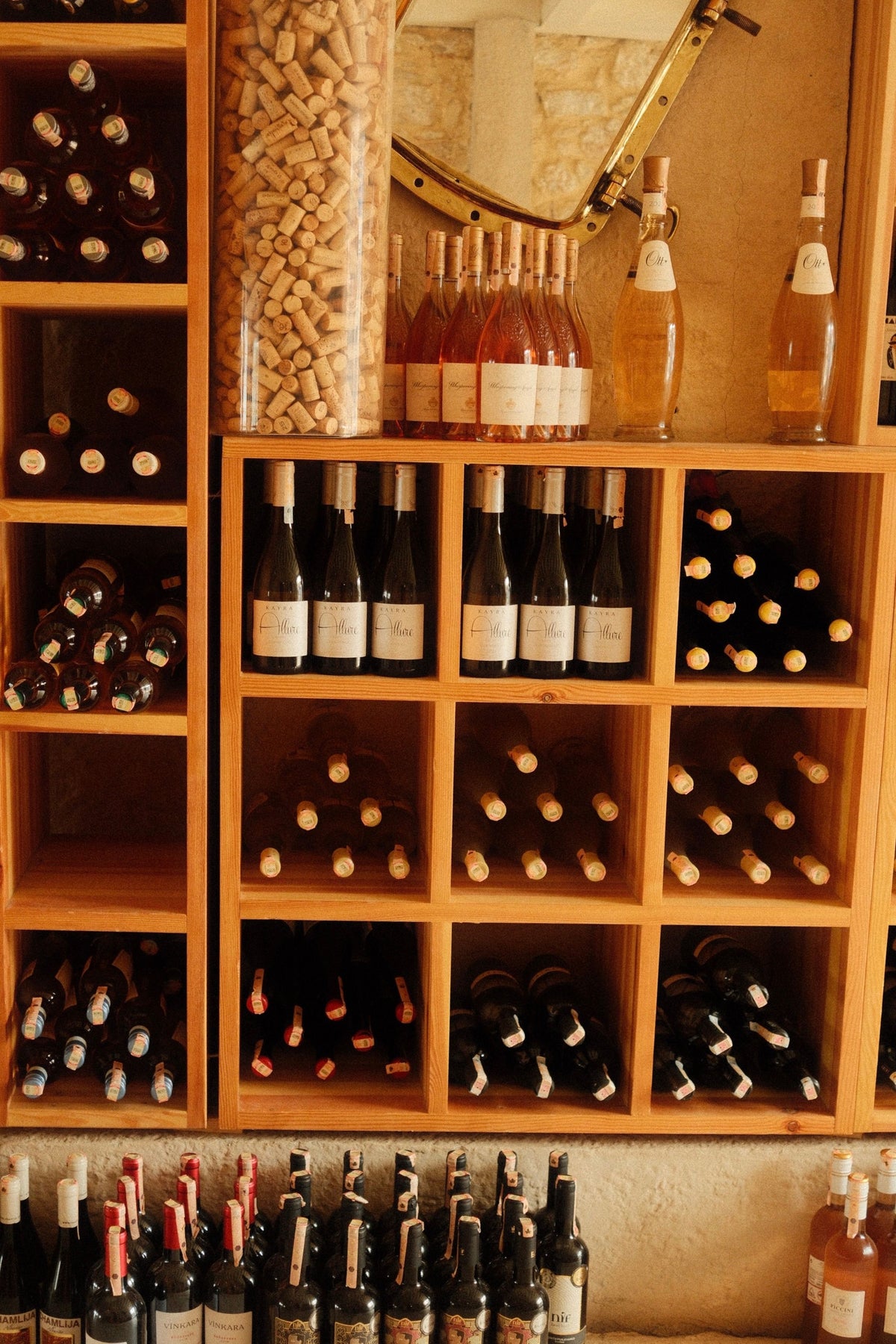 Wooden wine rack with a diverse collection of bottles
