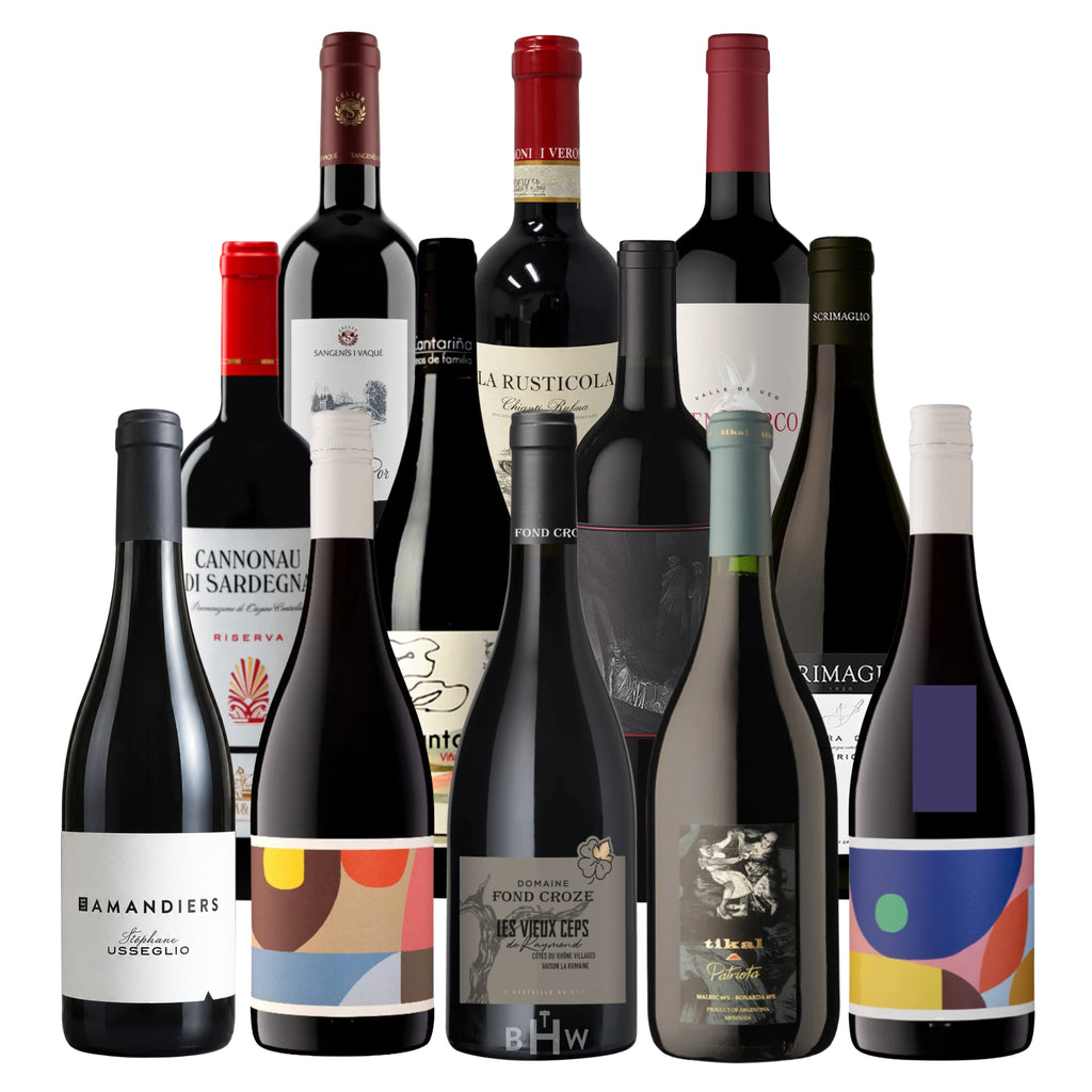 A tiered display of 12 value-driven red wine bottles from global regions, shown against a white background. This collection features a diverse selection including Domaine Fond Croze, Luke Reserve, La Rusticola Chianti, and Cannonau di Sardegna. The sampler highlights high-quality reds from France, Italy, and beyond, all under $25. Curated by Big Hammer Wines.