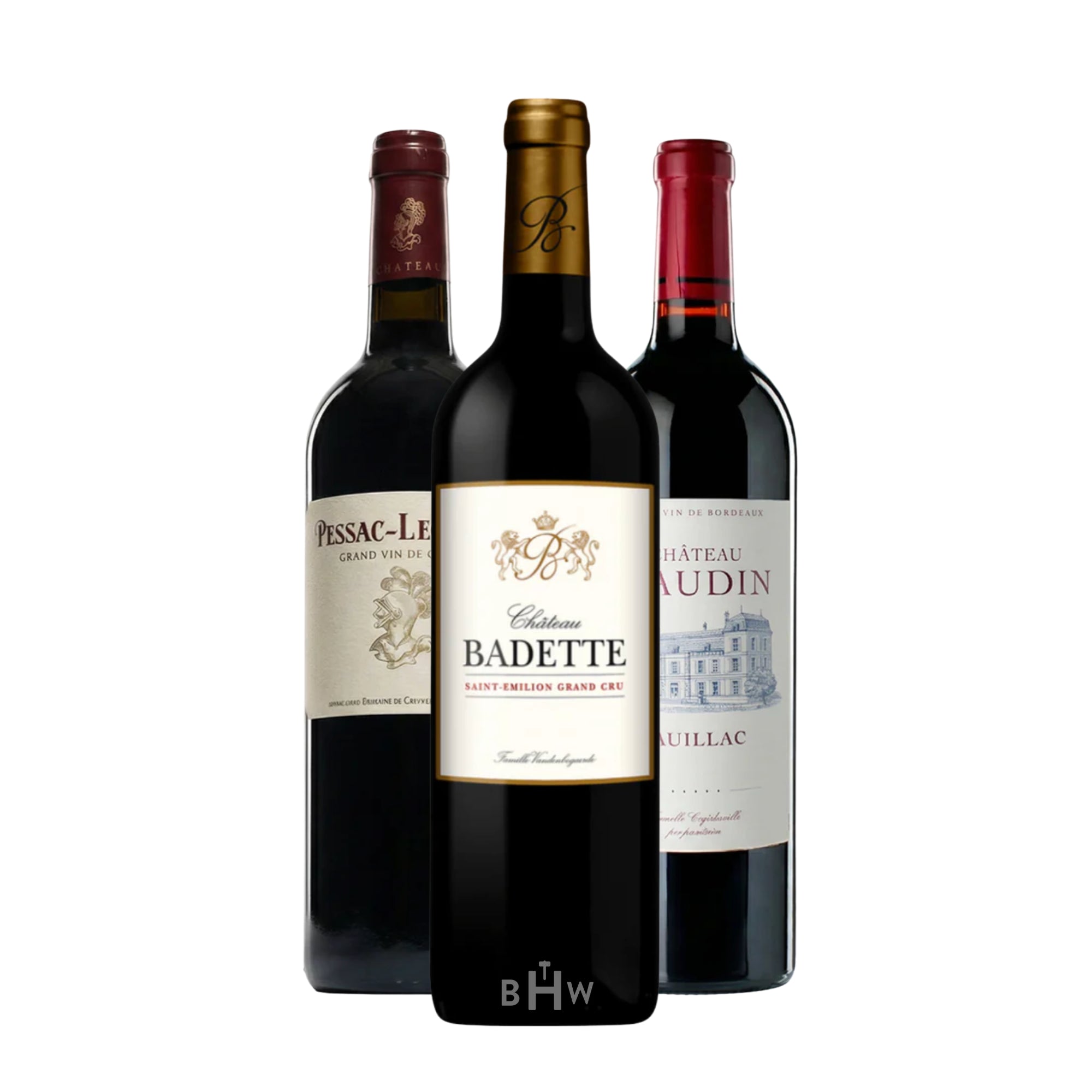 A trilogy of exceptional red Bordeaux wines presented in a professional group against a clean white background. The collection features a bottle of "Château Badette" Saint-Émilion Grand Cru at the center, flanked by a "Pessac-Léognan Grand Vin de Bordeaux" and a "Château Gaudin" Pauillac. This selection represents the prestigious Left and Right Bank regions of France. Curated by Big Hammer Wines.