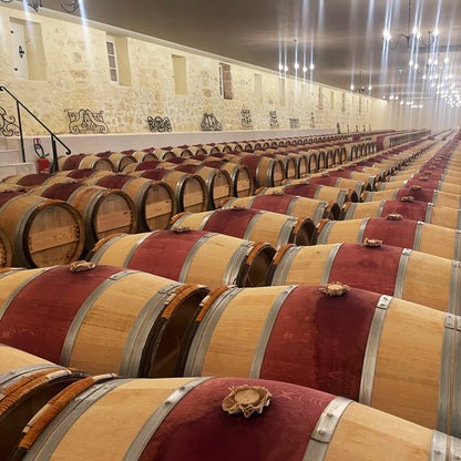 Barrel aging cellar at Château Léoville-Barton in Saint-Julien, Bordeaux, featuring rows of oak barrels for the estate’s renowned Grand Cru wines