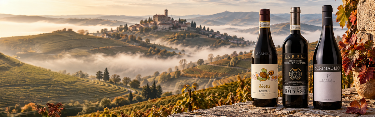 Three wine bottles on a stone ledge overlooking misty, rolling vineyard hills and an Italian village.
