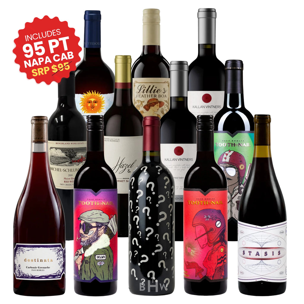 An assortment of 12 different red wine bottles from the Red Wine Lovers Case, featuring a mystery bottle with question marks in the center and a red sticker badge promoting an included 95-point Napa Cabernet, curated by big hammer wines.